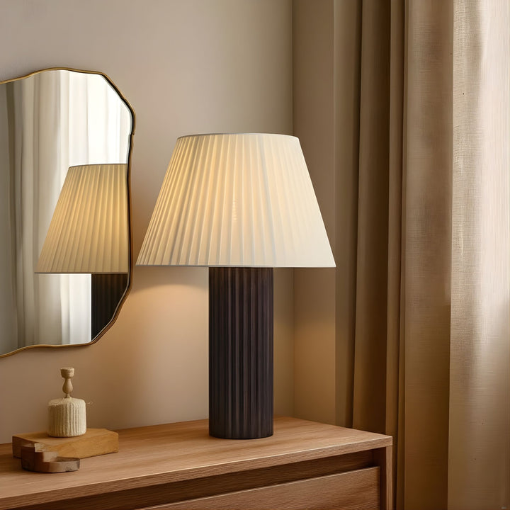 Bordslampa Aristo i sovrumsmiljö med spegel och träbyrå, elegant belysning med tidlös formgivning.