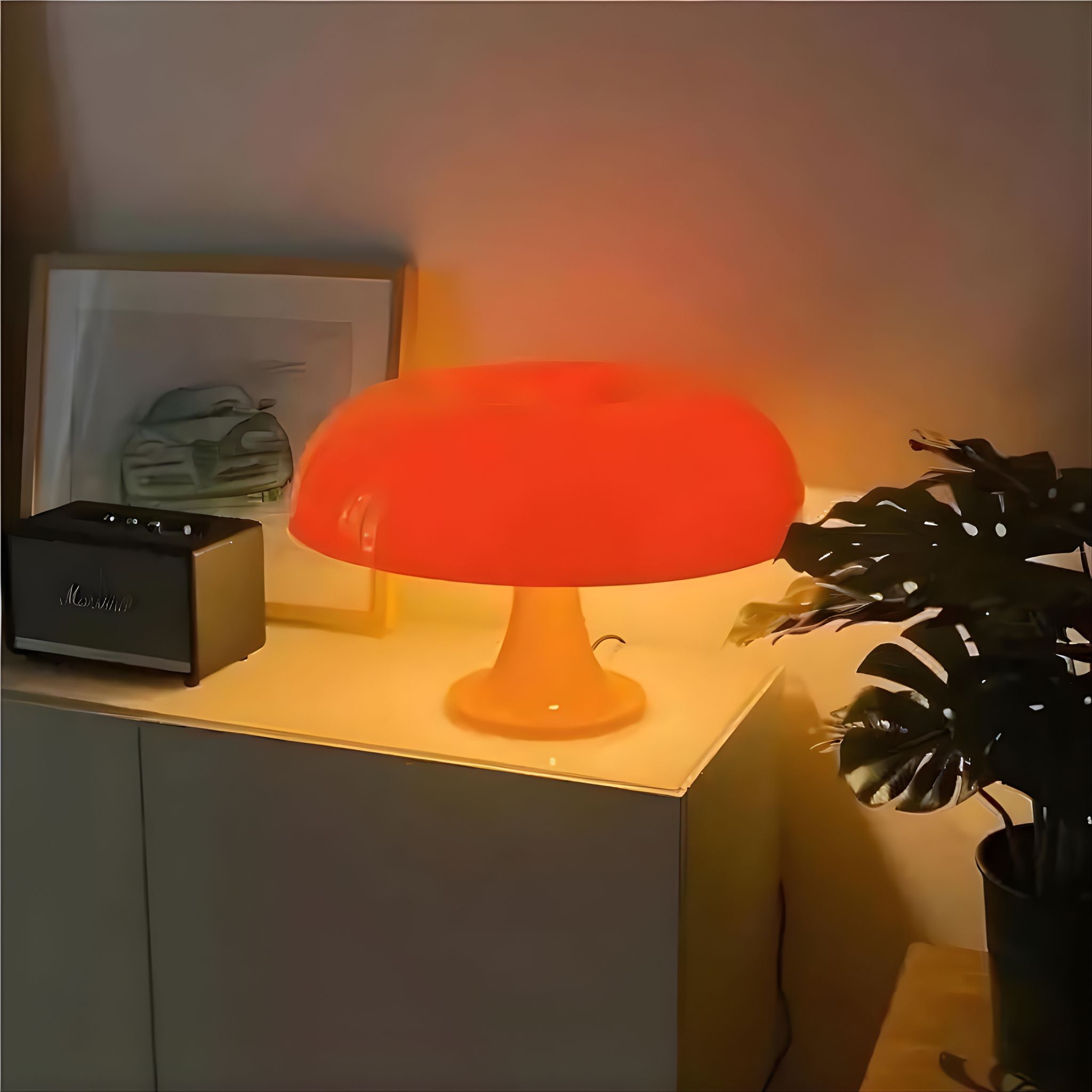 Orange retro bordslampa placerad på sidobord som ger varmt och stämningsfullt ljus i vardagsrum