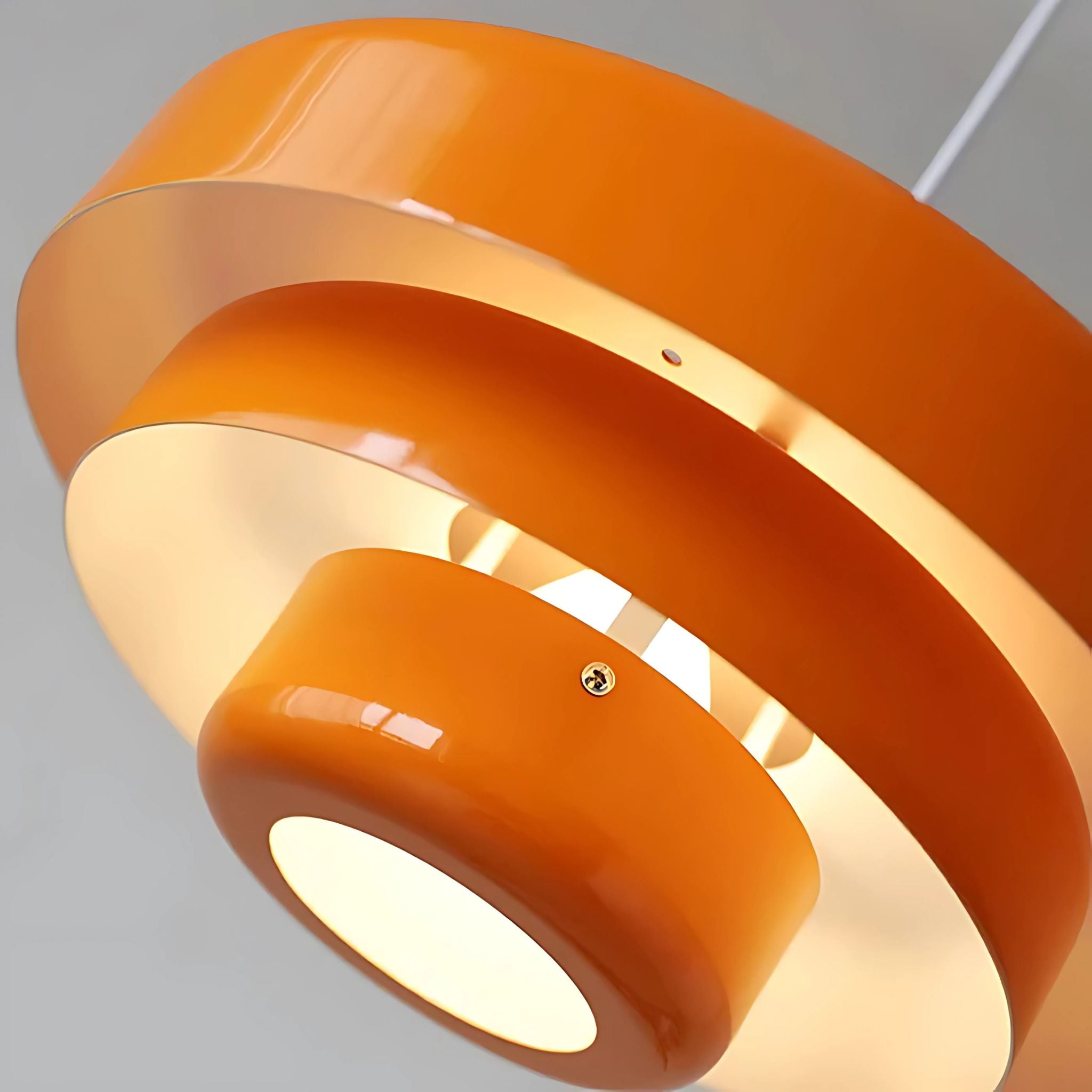 Detaljbild av Taklampa Italia i orange med blank yta och distinkt lagerformad design.